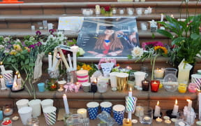 An image of Grace Millane amid candles at a vigil in Wellington, 12 December 2018.