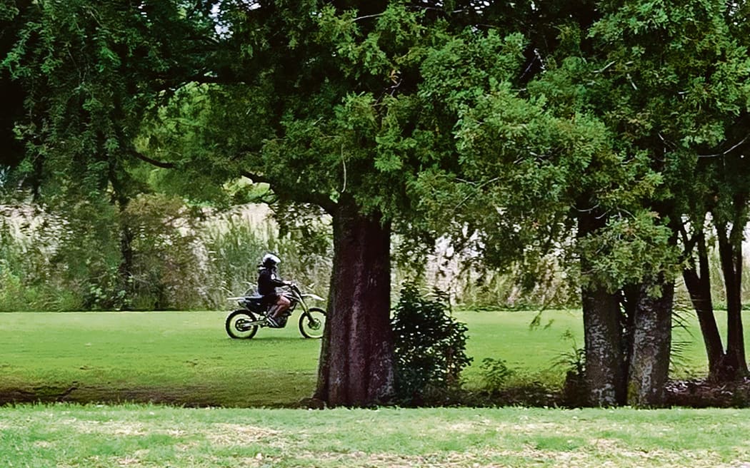 File photo: A motorcyclist rides on reserve land around Awatapu Lagoon.