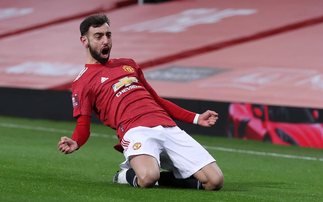 Manchester United's Portuguese midfielder Bruno Fernandes celebrates scoring his team's third goal during the English FA Cup fourth round football match between Manchester United and Liverpool at Old Trafford in Manchester on January 24, 2021.