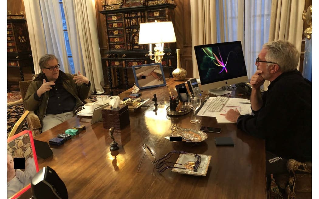 This undated photo from the personal collection of Jeffrey Epstein provided by the Democrats on the House Oversight Committee on 12 December, 2025, shows former Trump adviser Steve Bannon (left) speaking with Epstein. The image also shows two photos of people in frames on Epstein’s desk, their faces redacted by the committee.