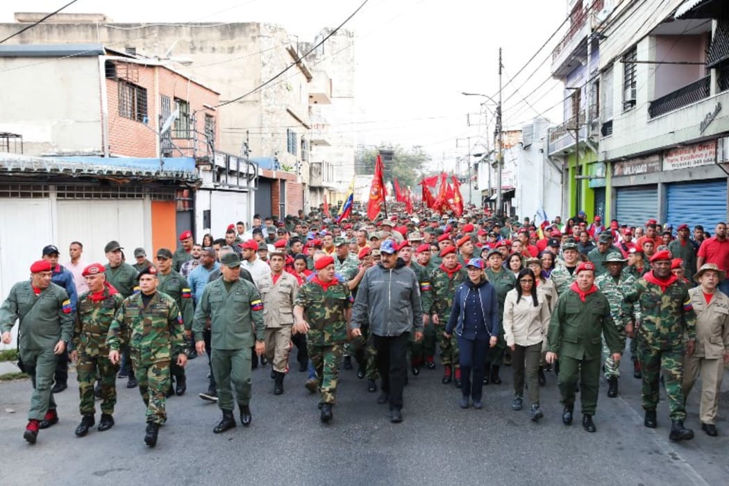 Handout picture released by the Venezuelan presidency showing Venezuela's President Nicolas Maduro (C) attending a military ceremony