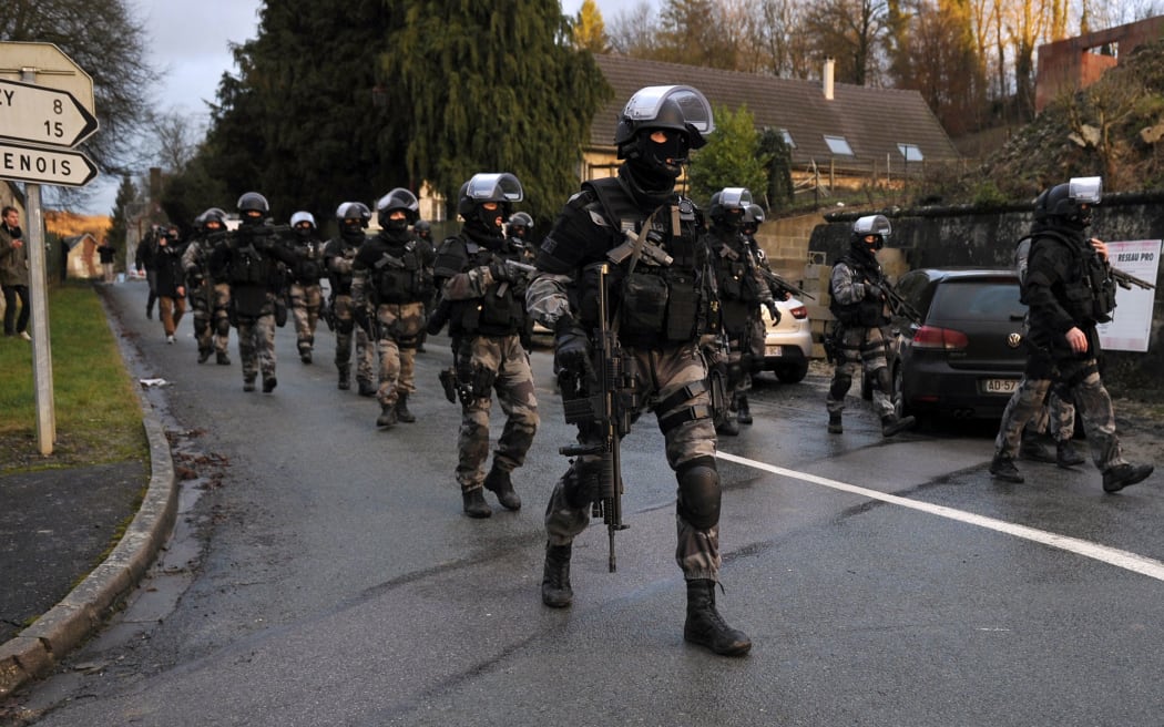 Members of the GIPN and RAID, French police special forces, walk in Corcy, northern France.