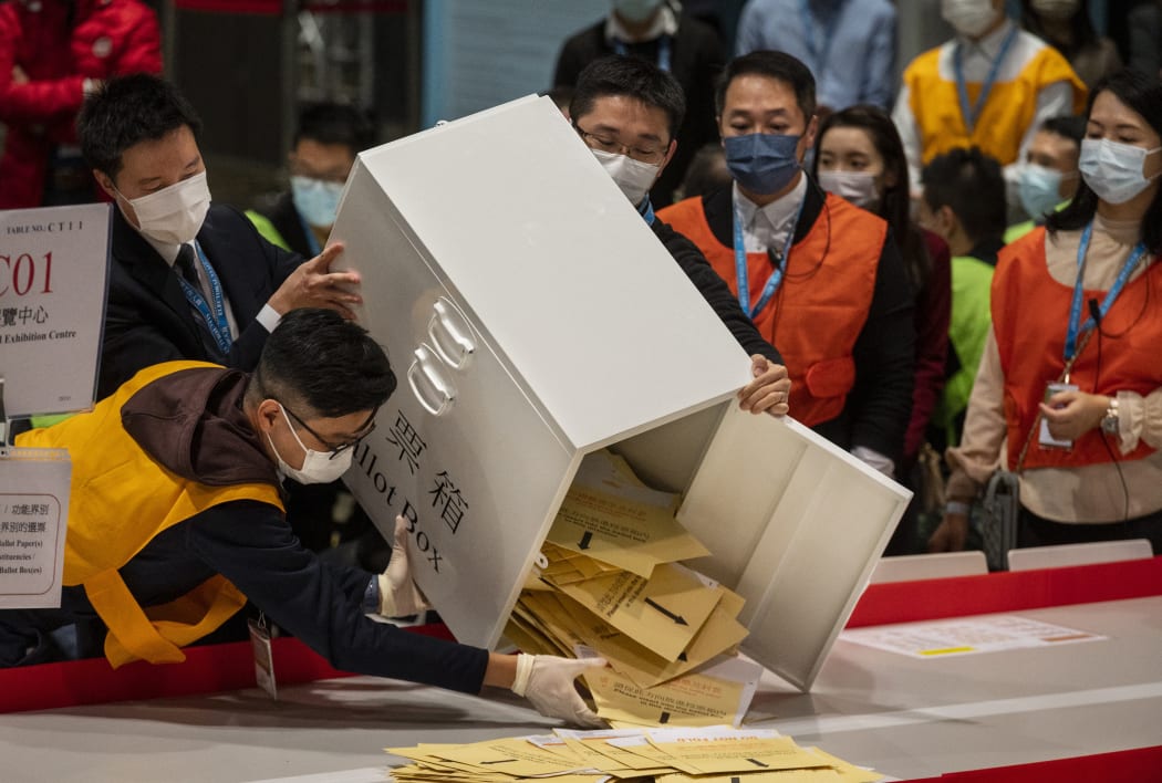 Officials empty a ballot box following the Legislative Council General Election in Hong Kong.
