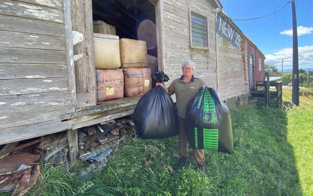 Ben Stubbs with two bags of possum fur worth more than his full wool shed.