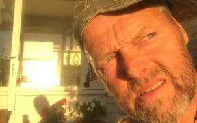 A portrait of Bruce Hopkins at home in Auckland, staring into the sun and wondering when he will get back on the trail.