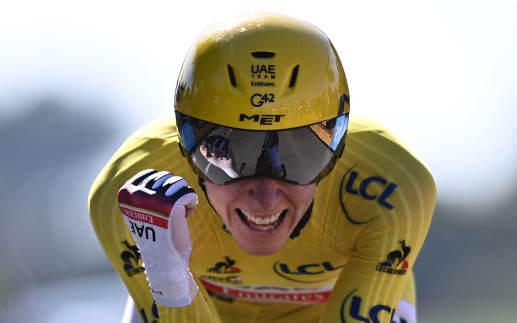 Team UAE Emirates' Tadej Pogacar of Slovenia celebrates after crossing the finish line during the 20th stage of the 108th edition of the Tour de France cycling race.