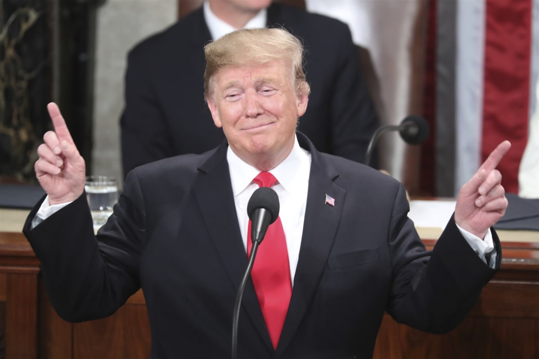 President Donald Trump gestures as a conductor as people in the chamber sing "Happy Birthday" to Judah Samet as he delivers his State of the Union address to a joint session of Congress on Capitol Hill in Washington, Tuesday, Feb. 5, 2019. Samet turned 81 on Tuesday.