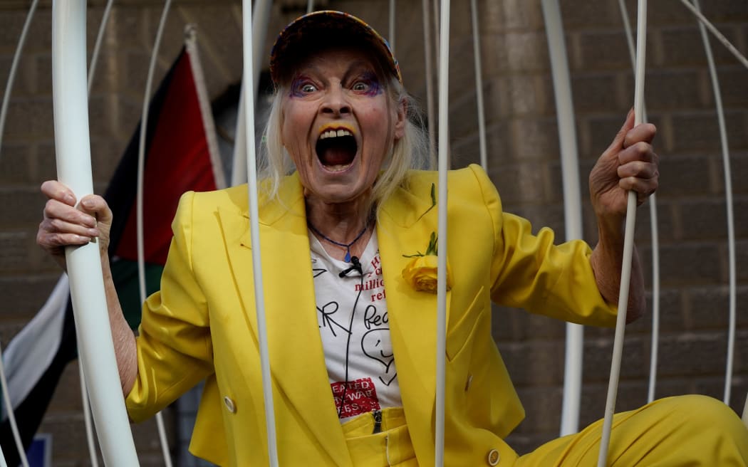 British designer Vivienne Westwood gesturing from inside a giant bird-cage, suspended in front Of the Old Bailey in central London, in protest of the extradition trial of Wikileaks founder Julian Assange, on 21 July, 2020.