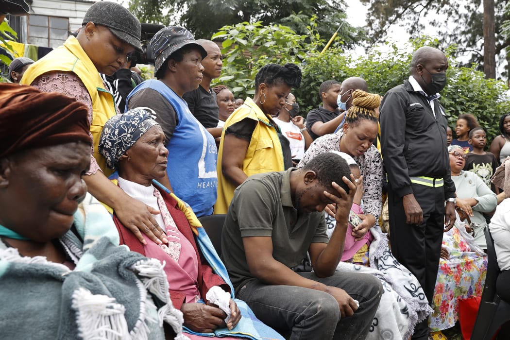 Various family members of the 4 children that passed away in the surrounding area following heavy rains and floods grieve at the United Methodist Church of South Africa in Clermont, near Durban, on April 13, 2022.