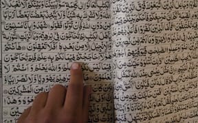 An Afghan boy reads the Quran at the Hazrat-e-Bilal madrassa in Kabul.