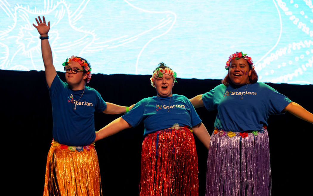 Three StarJam attendees on stage.