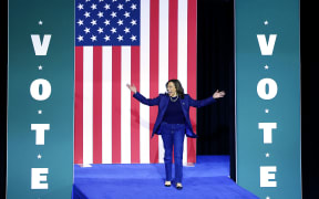 US Vice President and Democratic presidential nominee Kamala Harris walks on stage as she arrives for a campaign rally at Michigan State University's Jenison Field House in East Lansing, Michigan, on November 3, 2024. (Photo by JEFF KOWALSKY / AFP)