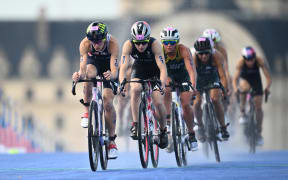 Taylor Knibb of USA and Kate Waugh of Great Britain lead Sophie Linn of Australia during the Women’s Individual Triathlon at Pont Alexandre III, as part of the 2024 Paris Olympic Games, in Paris, France.