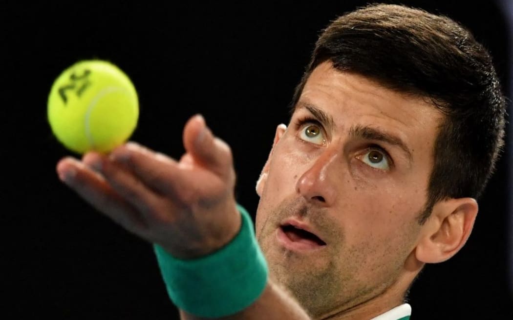 (FILES) In this file photo taken on February 21, 2021 Serbia's Novak Djokovic serves against Russia's Daniil Medvedev during the men's singles final on day fourteen of the Australian Open tennis tournament in Melbourne.