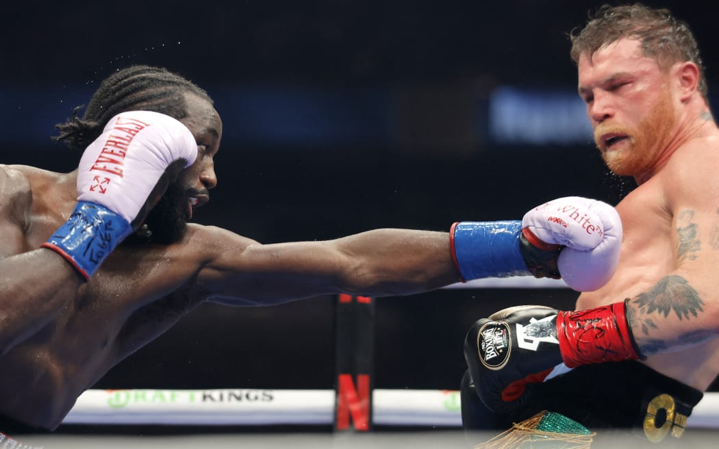 Terence Crawford throws a left at Canelo Alvarez in their undisputed super middleweight title fight during Netflix's Canelo v Crawford Fight Night at Allegiant Stadium.