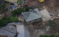 An aerial photo shows the site of landslide occurred due to typhoon in Hirao Town, Yamaguchi Prefecture, Japan on June 27, 2026. At around 7:40 p.m. on June 26th, mud and debris flowed into the first floor of a two-story house, and one man in his 70s is missing. Typhoon Mekkhala (No.7) and Higos (No.8) have moved north-northeast along the south of the Japanese archipelago.     ( The Yomiuri Shimbun ) (Photo by Takanobu Sawano / The Yomiuri Shimbun via AFP)