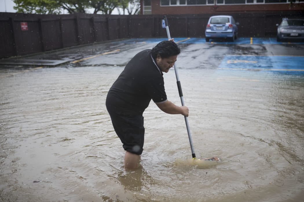 Water is swept out of the Petone Working Man's Club on 15 November 2016
