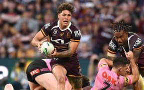 Reece Walsh of the Broncos as players melee in the background during the NRL Preliminary Finals match between the Brisbane Broncos and the Penrith Panthers.