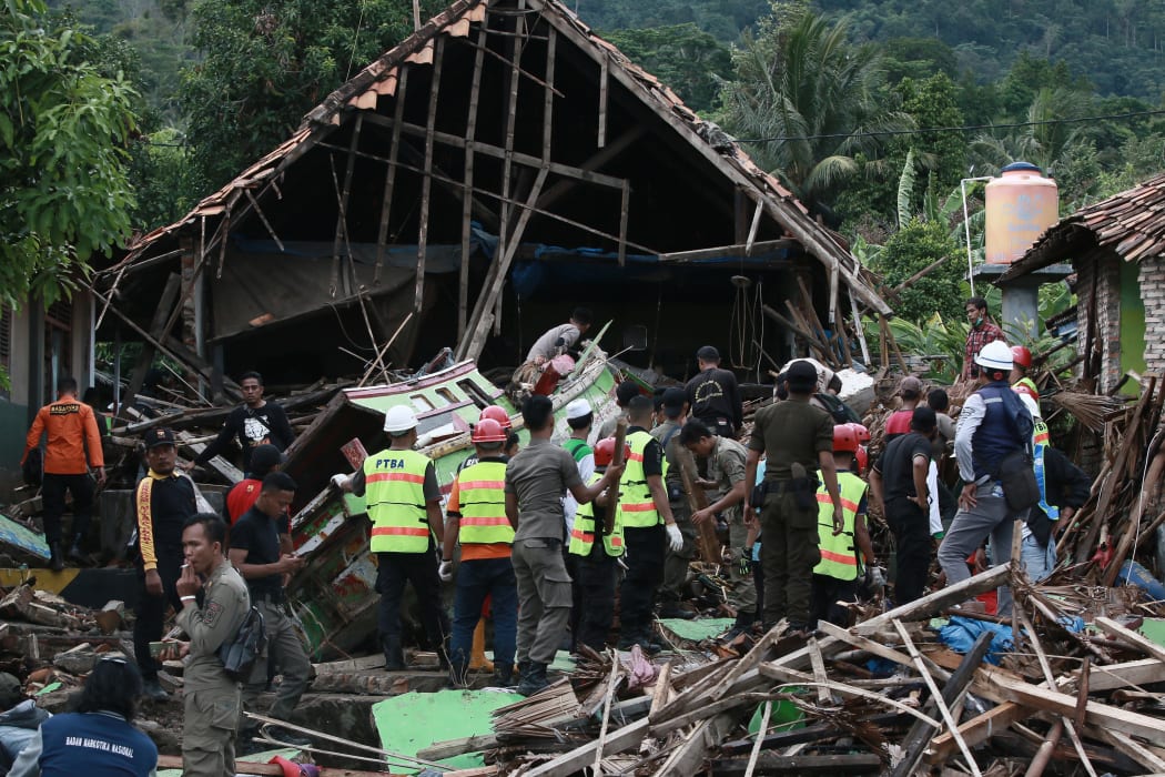 Rescuers look for survivors along the coast on South Sumatra, after the area was hit by a tsunami following an eruption of the Anak Krakatoa volcano.