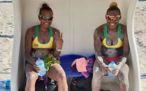 Miller Pata and Sherysyn Toko celebrate winning the Oceania Beach Volleyball Championship title.