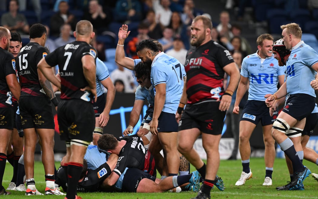 The Waratahs celebrate a try against the Crusaders, 2024.