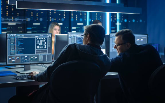 Team of IT Programers Working on Desktop Computers in Data Center Control Room. Team of Young Professionals Working In Software and Hardware Development, Doing Coding