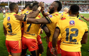 Papua New Guinea celebrate a try against Fiji.