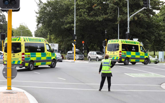 Ambulances leave the scene of the shooting.