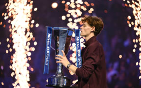 Italy's Jannik Sinner kisses the trophy after winning over Spain's Carlos Alcaraz at the end of the men's single final match at the ATP Finals tennis tournament, in Turin, on November 16, 2025. (Photo by Marco BERTORELLO / AFP)
