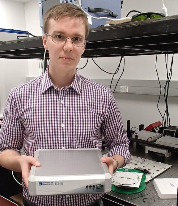 Physicist Miro Erkintalo holds an ultra-fast laser developed at the University of Auckland.
