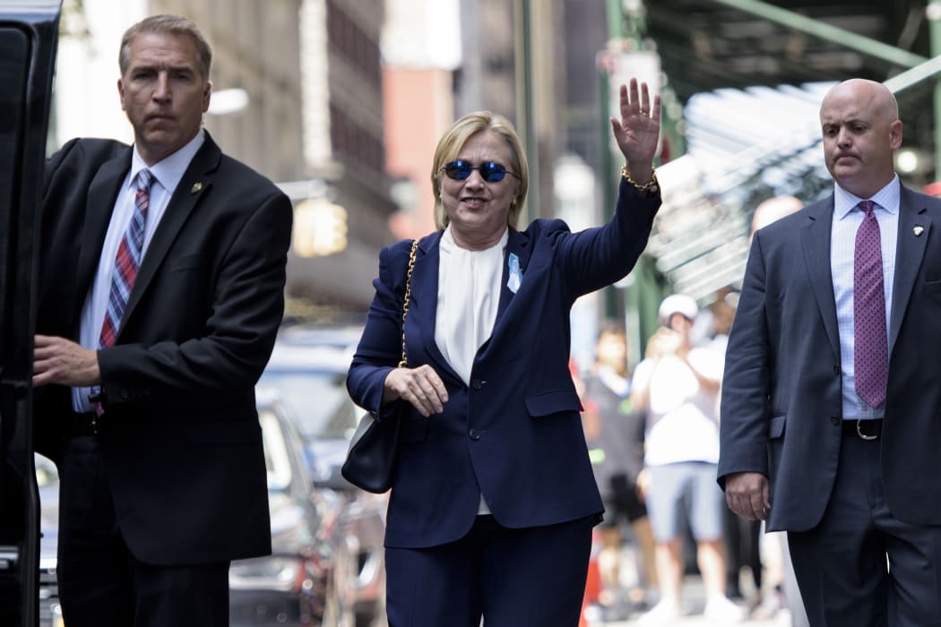 Hillary Clinton leaves her daughter's apartment building in New York where she rested after leaving a  9/11 memorial ceremony feeling unwell.