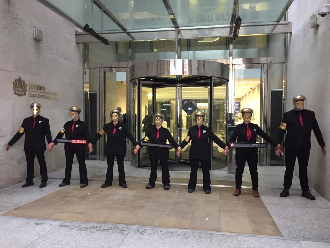 Extinction Rebellion protesters barricade the entrance to the London Stock Exchange on 25 April, 2019.
