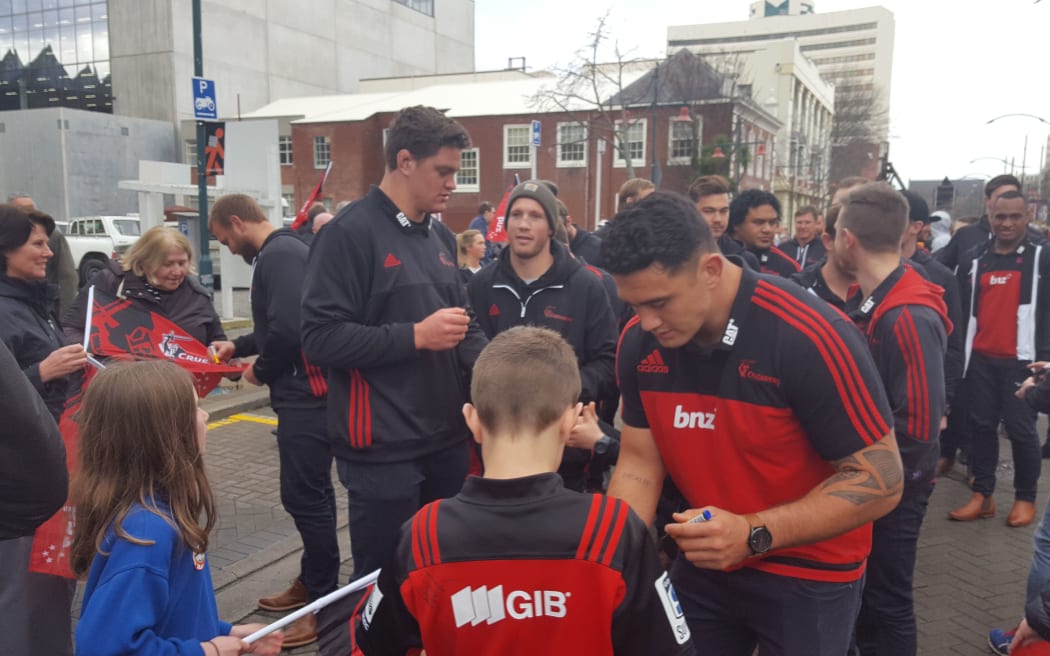 Crusaders players with fans in Christchurch today.