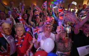 Brexit supporters wave Union flags as the time nears 11 O'Clock at a Brexit Celebration party at Woolston Social Club in Warrington, north west England on January 31, 2020, the day that the UK formally leaves the European Union.