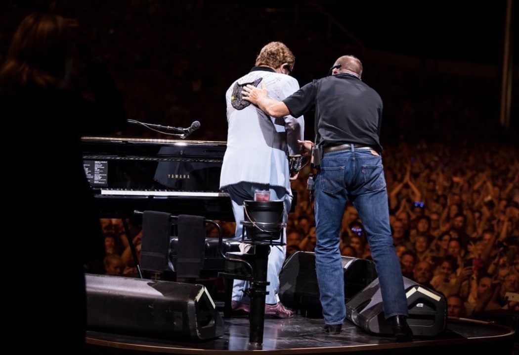 Elton John leaves the stage after ending his show early.
