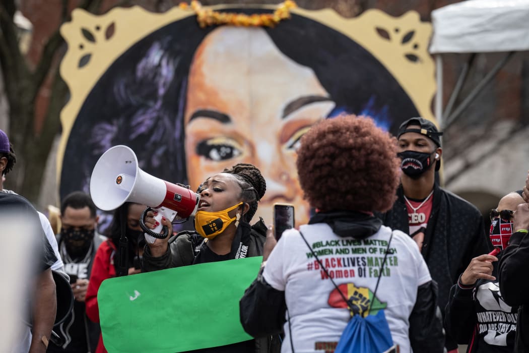 A woman shouts through a megaphone during a protest memorial for Breonna Taylor in Jefferson Square Park, Louisville, Kentucky.