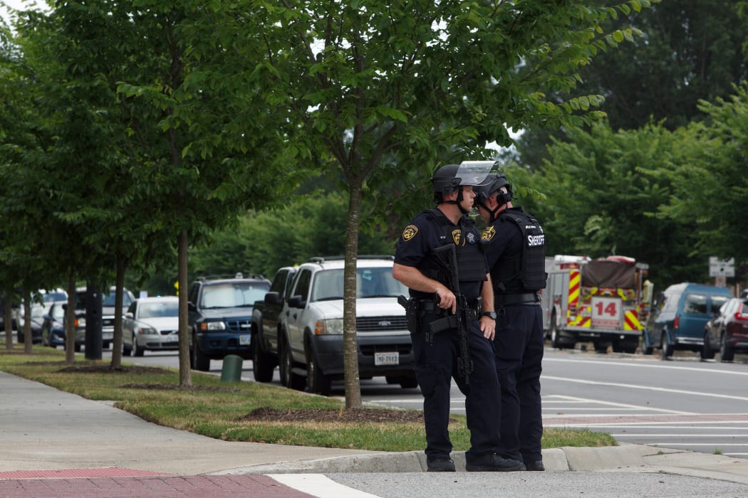 Virginia Beach Police Officers near the intersection of Princess Anne Road and Nimmo Parkway following a shooting at the Virginia Beach Municipal Center on Friday, May 31, 2019