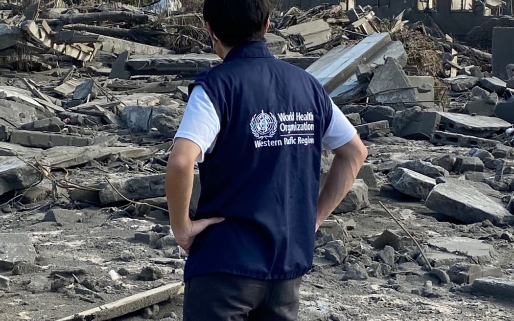 A WHO staff member surveying damage from the January 15 volcanic eruption and tsunami on Tonga's main island of Tongatapu. 2022