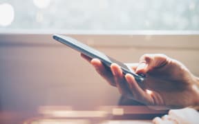 Close up of man's hand using smartphone with effects