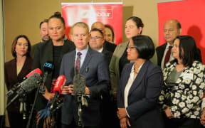 Opposition leader Chris Hipkins (centre) speaks to media after making his State of the Nation speech on 7 March, 2025.
