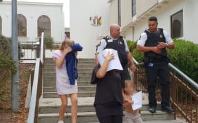 Tina Maria Cash (center) leaves the Hamilton district Court.