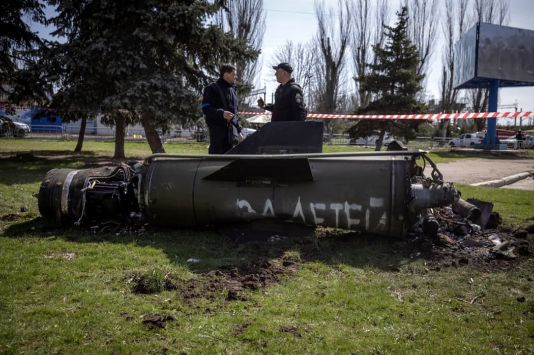 Ukrainian police inspect the remains of a large rocket with the words "for our children" in Russian near a train station in Kramatorsk, eastern Ukraine, that was hit by a rocket attack killing at least 35 people, on April 8, 2022.