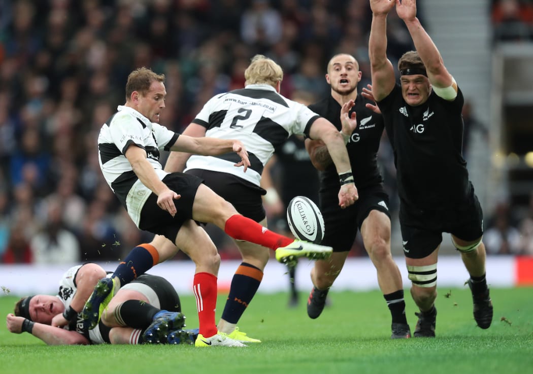 New Zealand All Blacks Scott Barrett  tries to block down Barbarians Andy Ellis