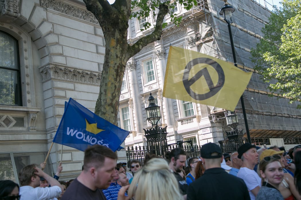 A man holds a Generation Identity flag at the Day for Freedom event in London, in 2018.