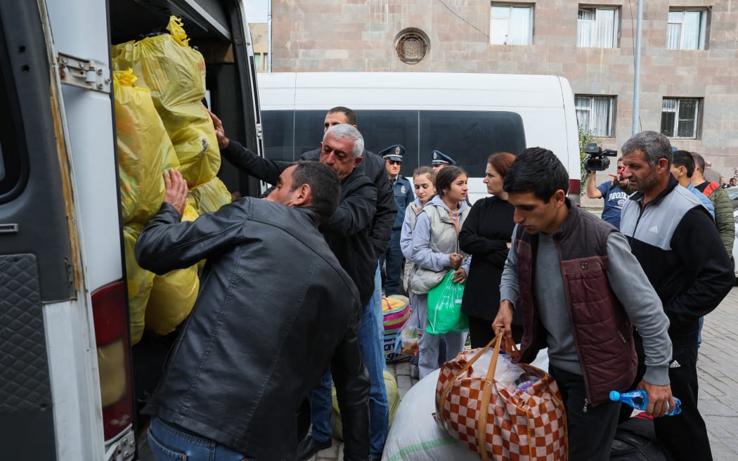 Refugees load their cars as they leave the Red Cross registration center, in Goris, on September 25, 2023. The first group of Nagorno-Karabakh refugees since Azerbaijan's lighting assault against the separatist region entered Armenia on September 24, 2023, an AFP team at the border said. The group of a few dozen people passed by Azerbaijani border guards before entering the Armenian village of Kornidzor, where they were registered by officials from Armenia's foreign ministry. (Photo by ALAIN JOCARD / AFP)