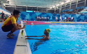 Papua New Guinea swimmer Leonard Kalate gets some last minute coaching advice in Buenos Aires.