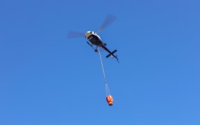 Water bombers fill up before returning to fight the Nelson bushfire.