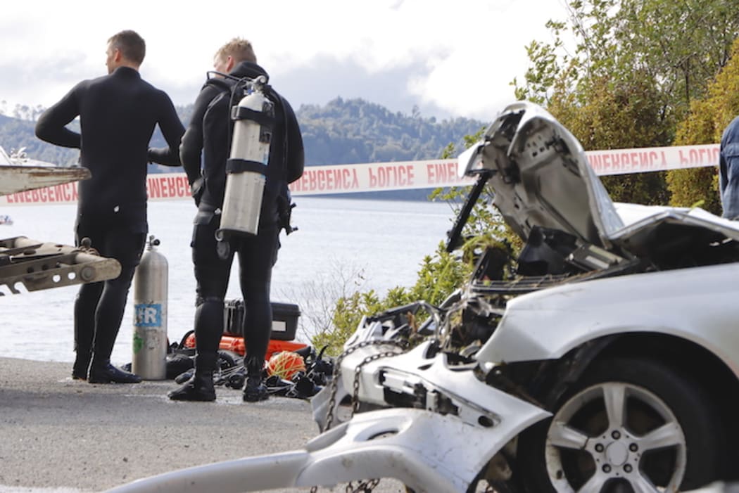 Police divers after the submerged car was recovered from Lake Rotoma.