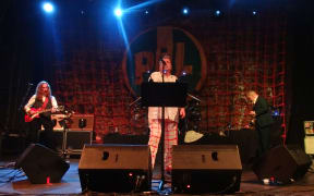 Public Image Ltd. on stage performing in 2013.