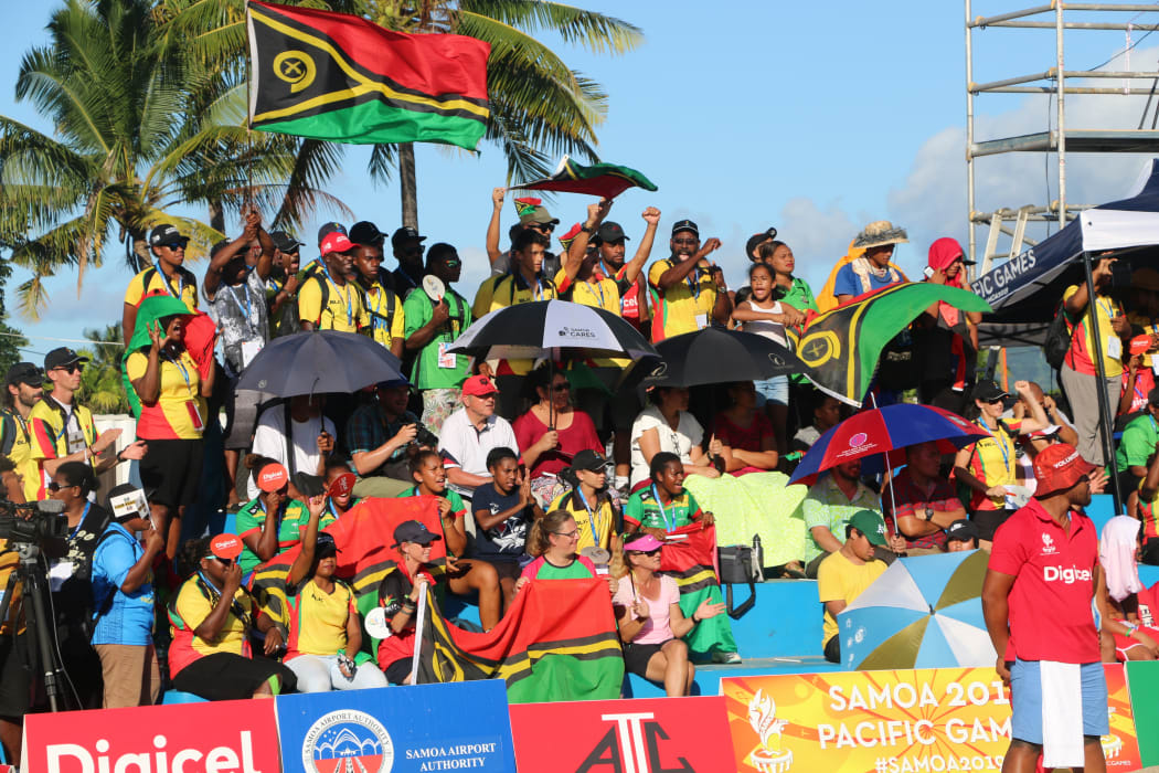Vanuatu fans show their support during the women's beach volleyball final.